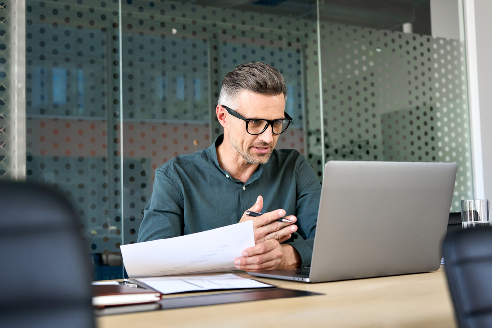 A leader rehearsing materials at a laptop, applying Portico methodology to real work